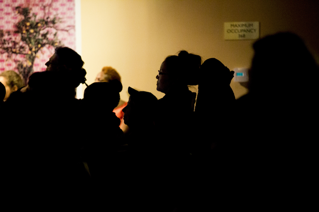 A silhouette of attendees watching films.