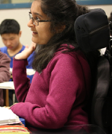 Headshot of Vyoma in a classroom setting, raising her hand