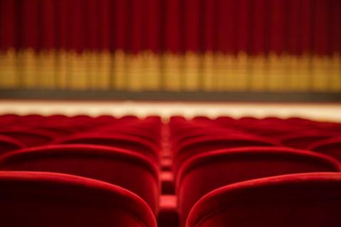 A generic shot of plush red theater seating
