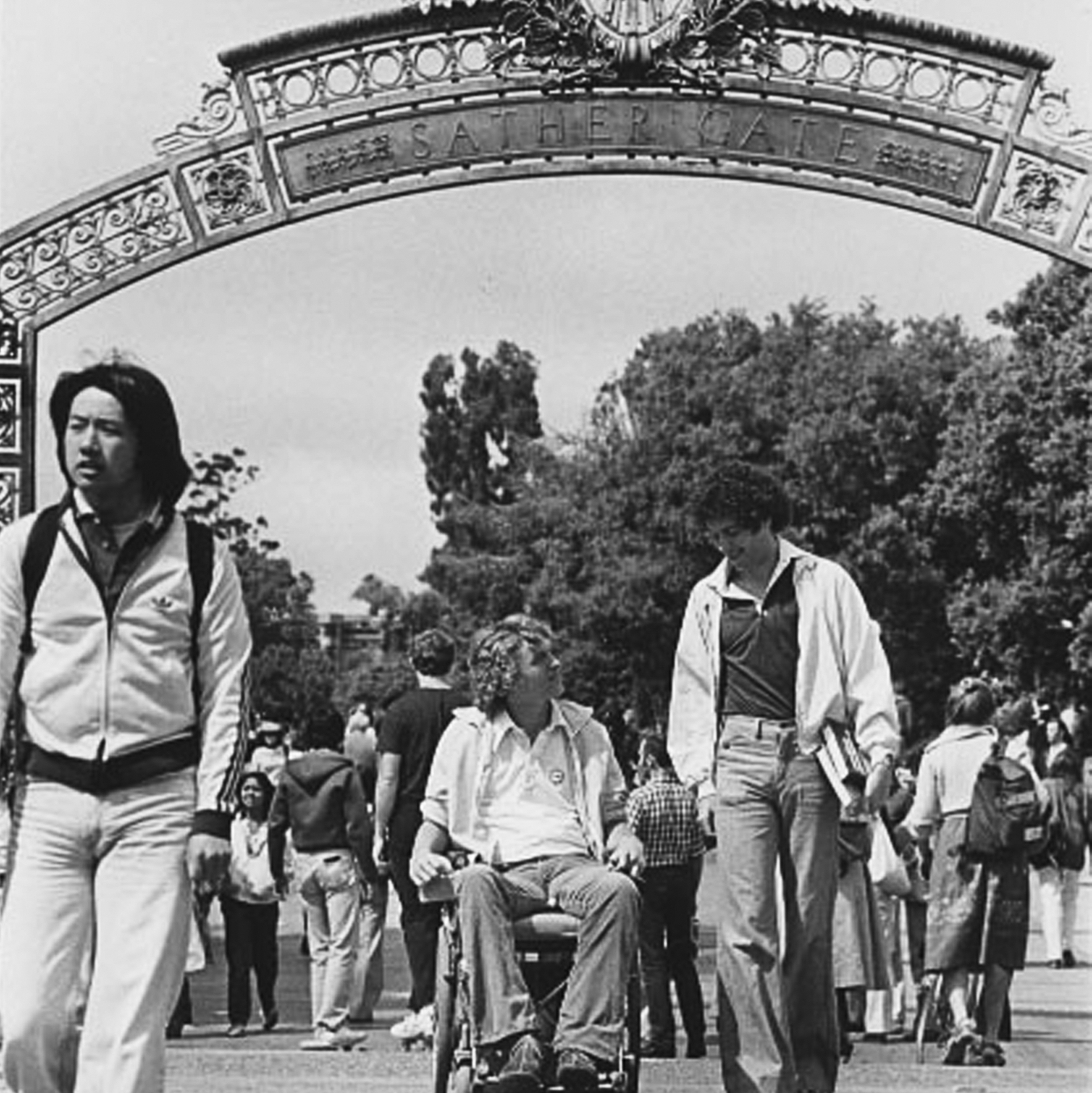 Sather Gate man in wheelchair and others walking